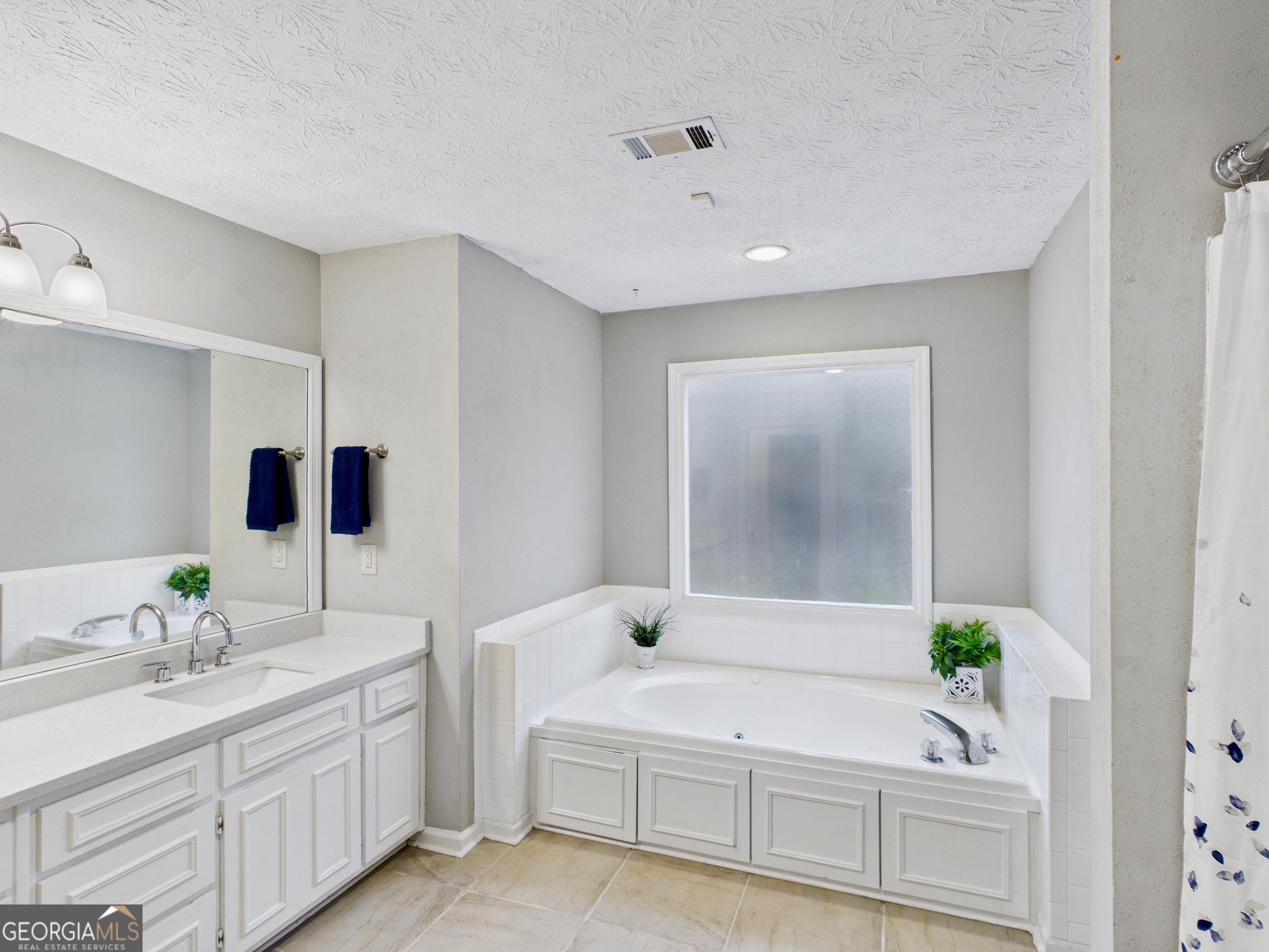 292 Blue Bird Trail Fortson, GA 31808 - Photo 25 of 45 a bathroom with a double vanity sink and a mirror