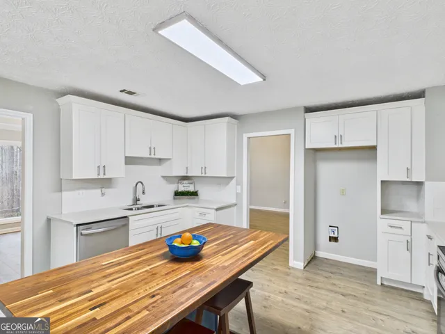 a open kitchen with stainless steel appliances granite countertop a refrigerator and a stove top oven
