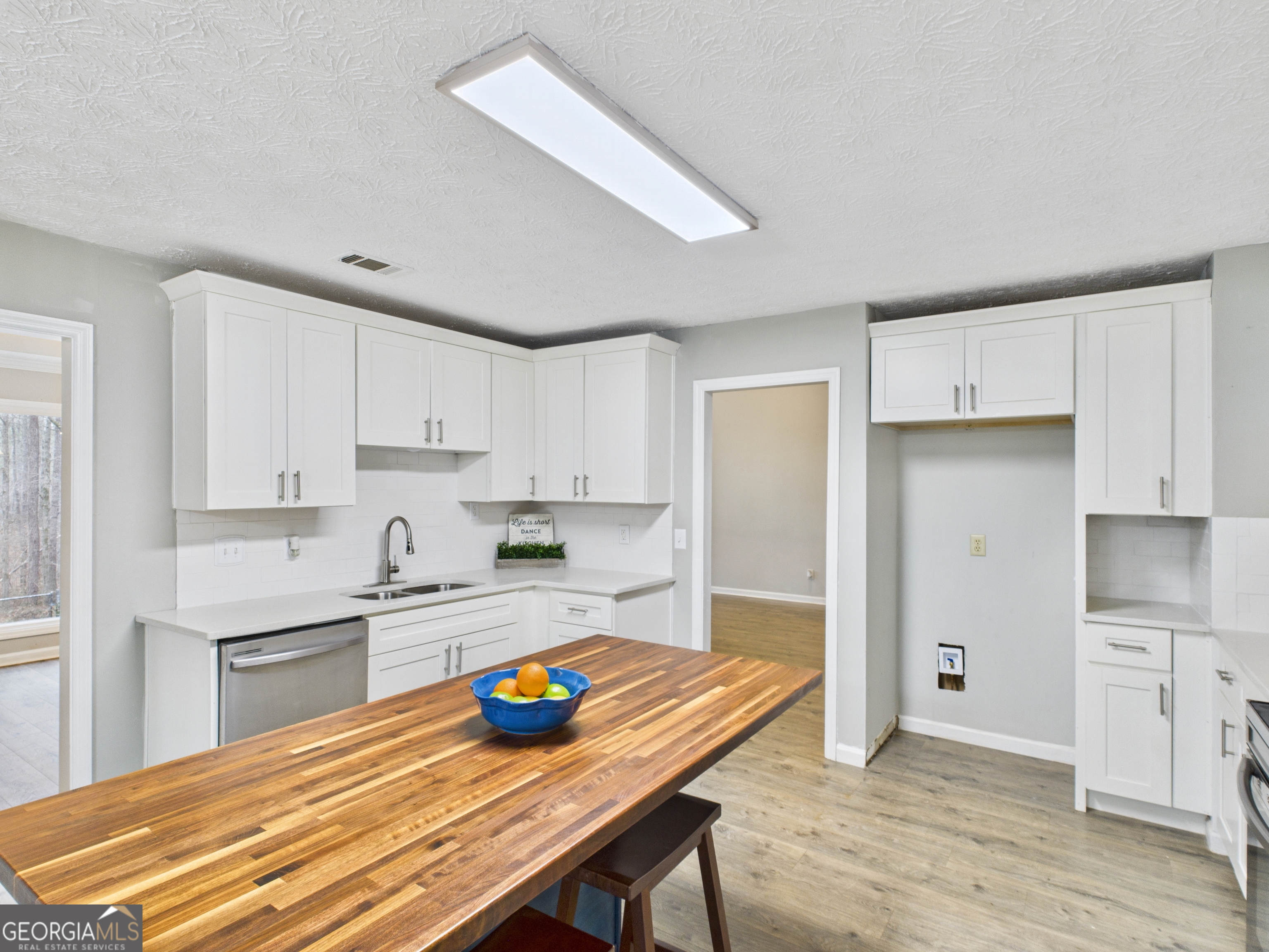 292 Blue Bird Trail Fortson, GA 31808 - Photo 9 of 45 a kitchen with a table chairs refrigerator and cabinets
