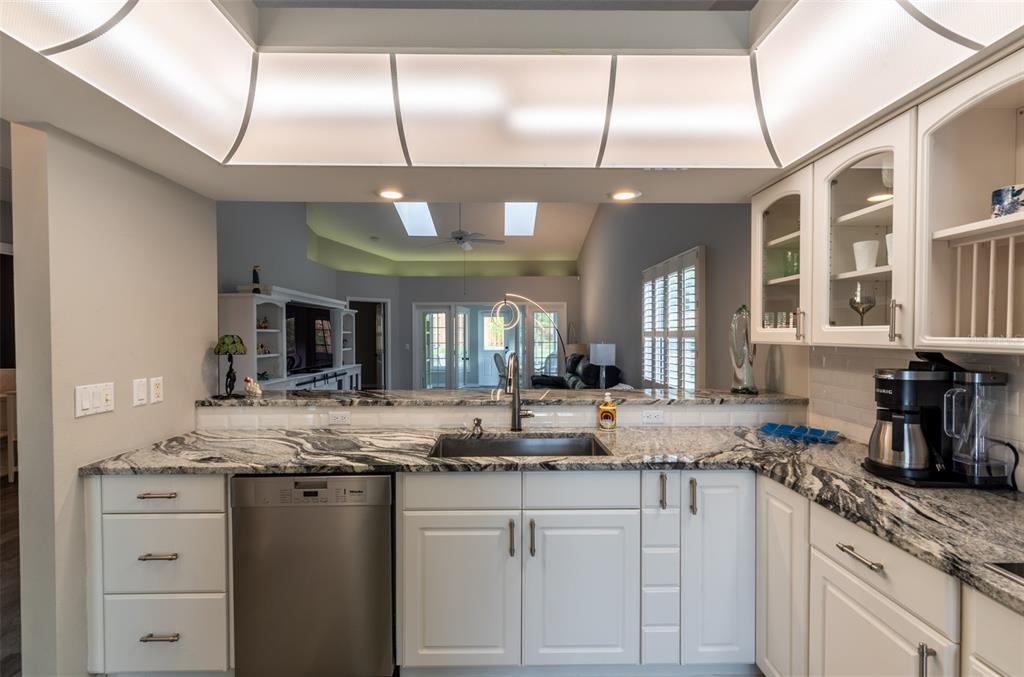 747 Inverie Drive Inverness, FL 34453 - Photo 11 of 40 a kitchen with granite countertop a sink and a stove