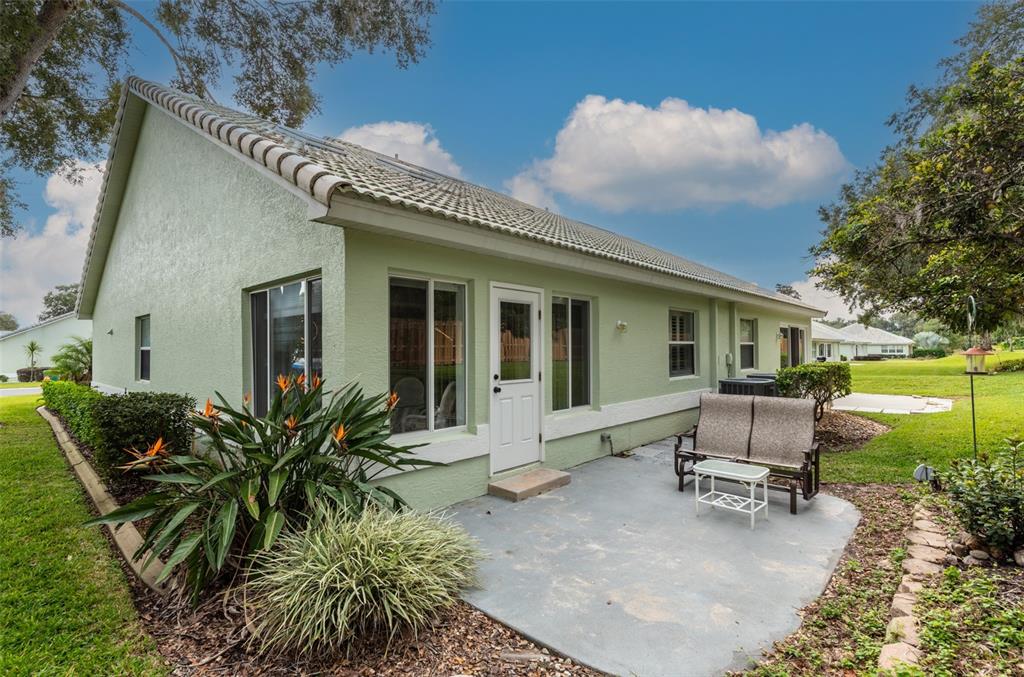 747 Inverie Drive Inverness, FL 34453 - Photo 19 of 40 a view of a house with backyard sitting area and garden