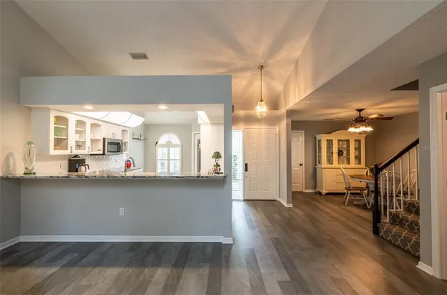 a view of a big room with wooden floor and staircase