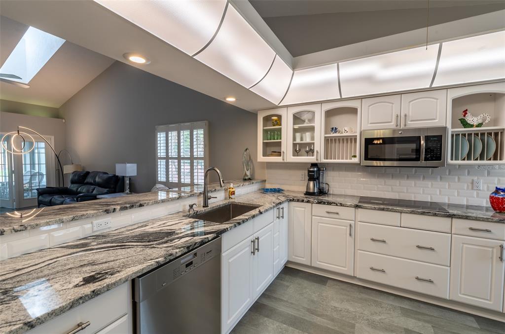 747 Inverie Drive Inverness, FL 34453 - Photo 2 of 40 a kitchen with stainless steel appliances granite countertop a sink stove and cabinets