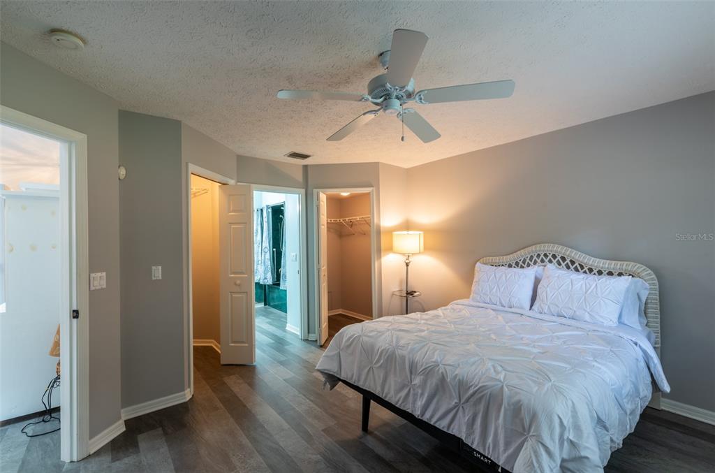747 Inverie Drive Inverness, FL 34453 - Photo 26 of 40 a bedroom with a large bed and a chandelier