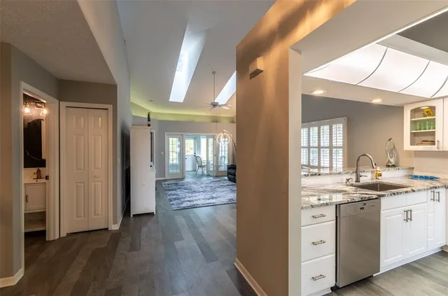 a view of a bathroom with a sink cabinet and wooden floor