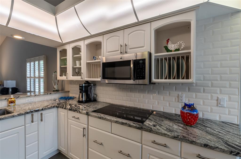 747 Inverie Drive Inverness, FL 34453 - Photo 9 of 40 a kitchen with stainless steel appliances granite countertop a sink a stove and cabinets