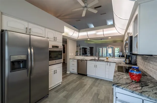 a kitchen with refrigerator and cabinets