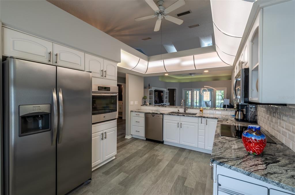 747 Inverie Drive Inverness, FL 34453 - Photo 10 of 40 a kitchen with refrigerator and cabinets