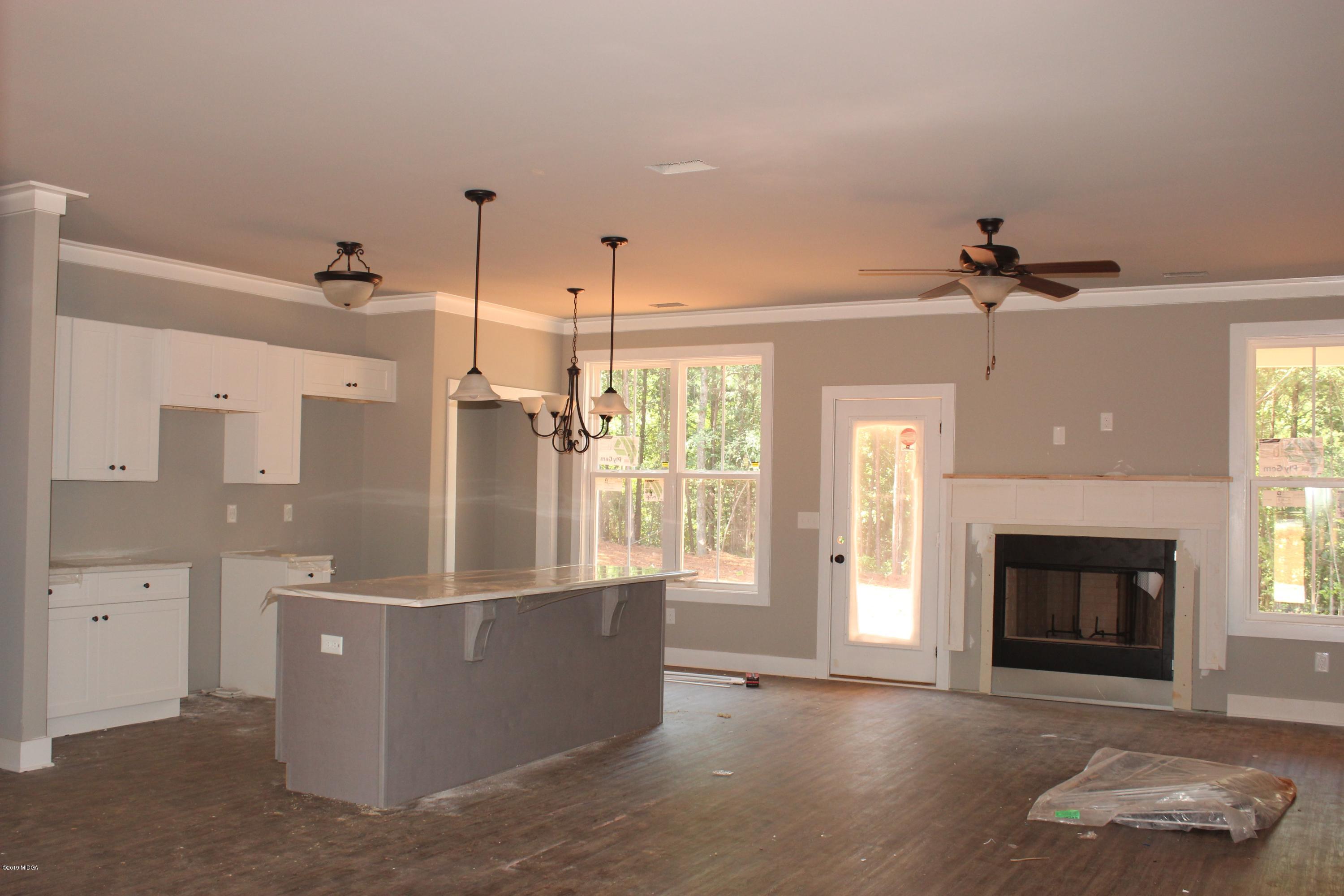 2748 Boxankle Road Forsyth, GA 31029 - Photo 3 of 6 a view of a living room a fireplace with a chandelier