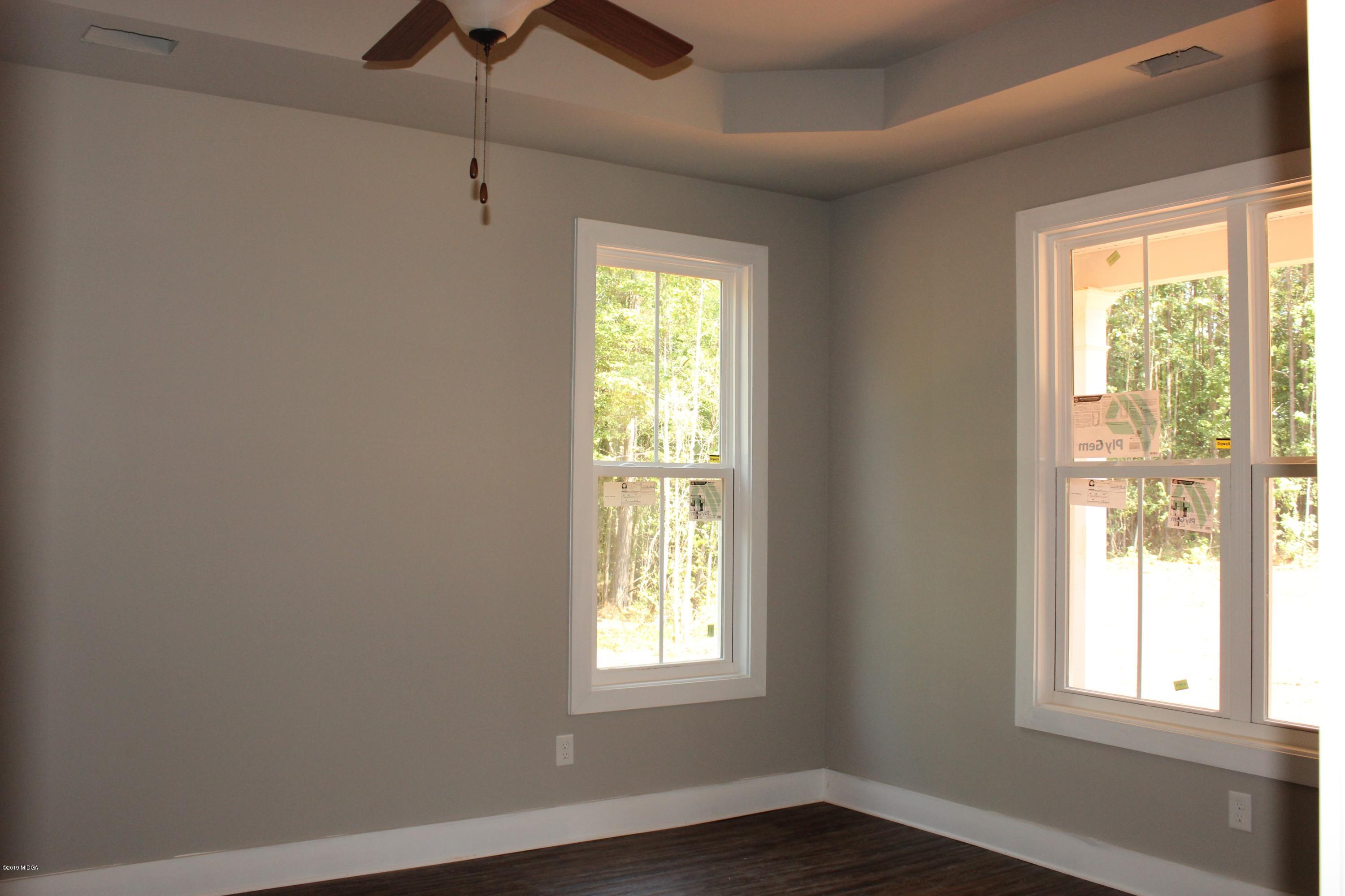 2748 Boxankle Road Forsyth, GA 31029 - Photo 5 of 6 a view of an empty room with a window and wooden floor