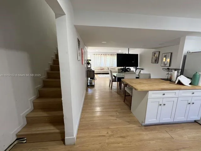 a view of living room with furniture and flat screen tv