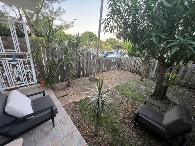 a view of patio with couches and a fire pit