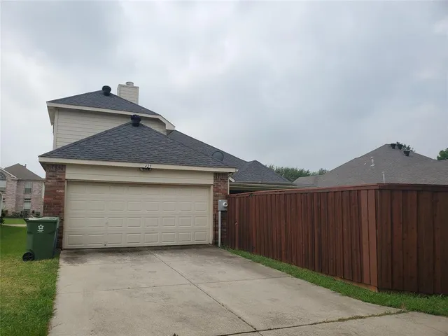 a front view of a house with parking space