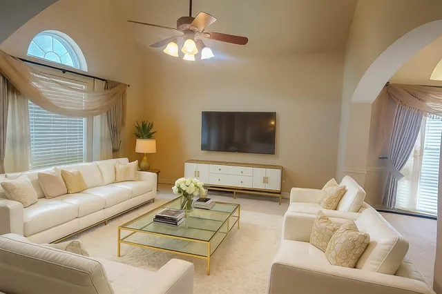 a living room with furniture and a flat screen tv