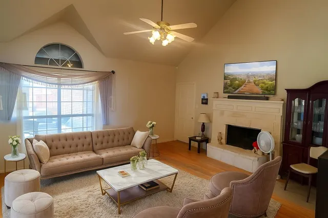 a living room with furniture a fireplace and a flat screen tv