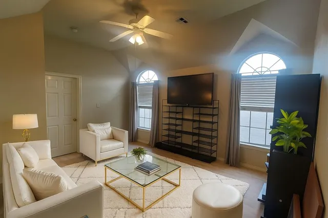 a living room with furniture and a flat screen tv