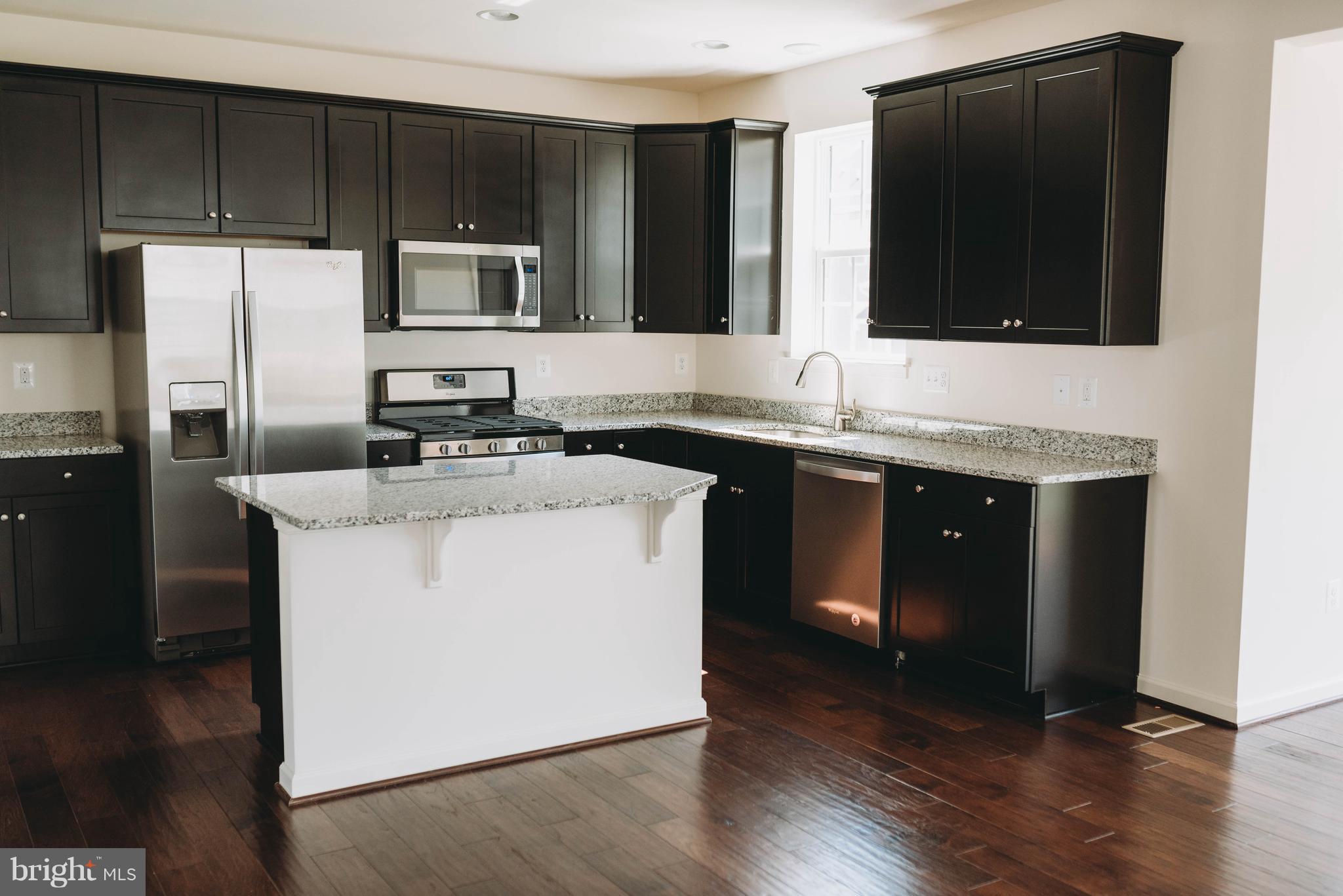 976 Morgan Run Road Middle River, MD 21220 - Photo 2 of 6 a kitchen with a sink a microwave a refrigerator and cabinets