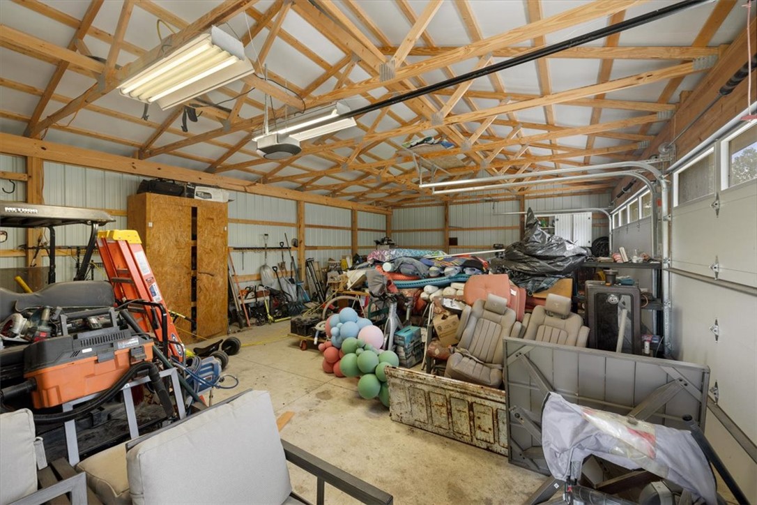5120 Wheelock Road Troy, OH 45373 - Photo 59 of 67 This spacious garage offers ample storage and utility with its exposed beam ceiling and concrete flooring.