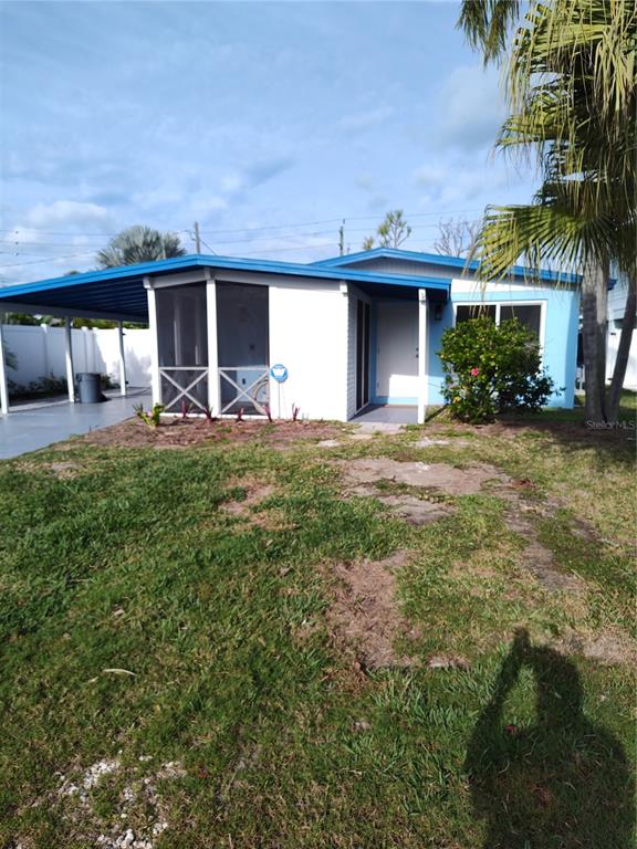 306 Magnolia Avenue Anna Maria, FL 34216 - Photo 2 of 2 a front view of a house with patio