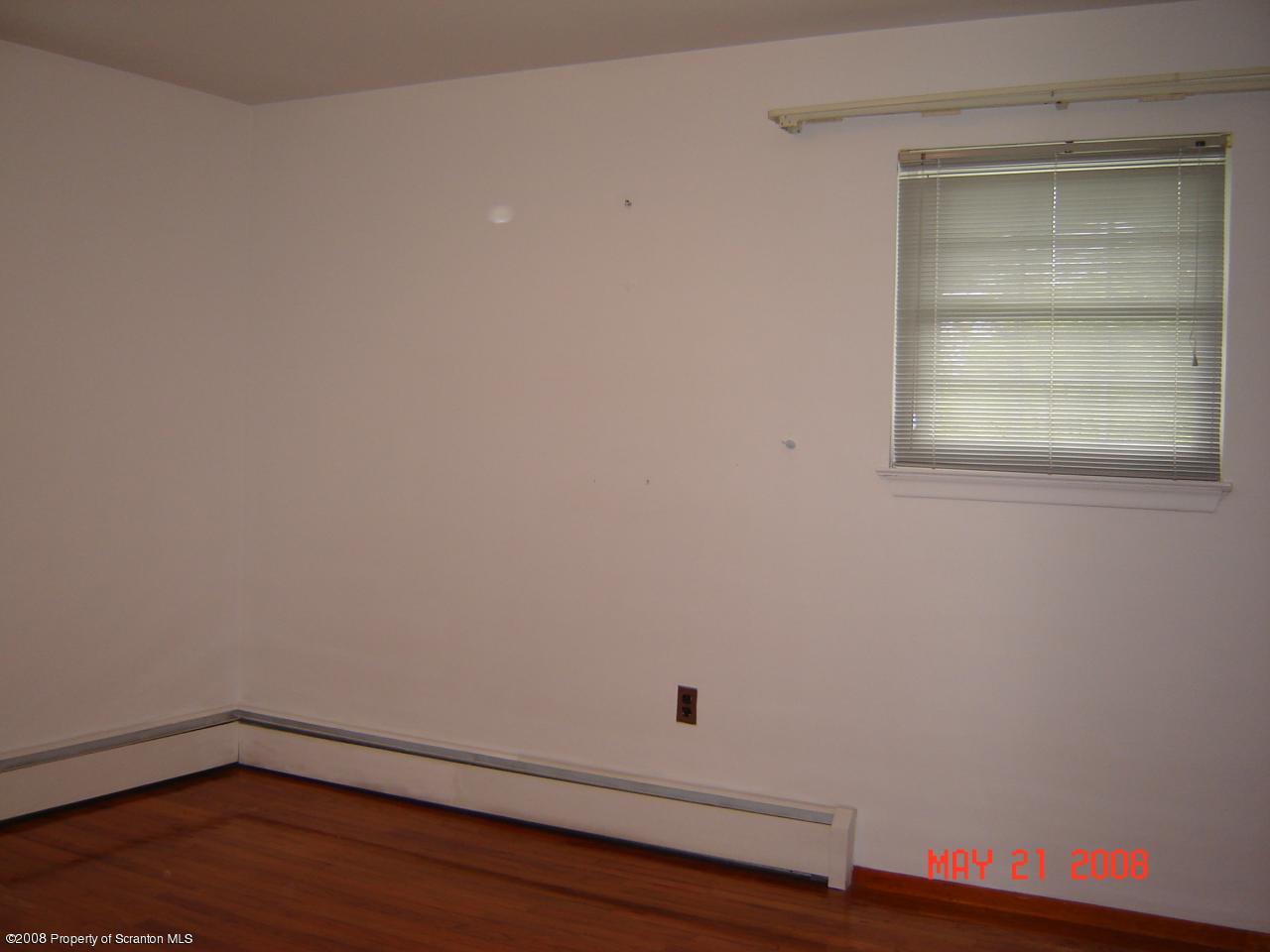 2343 T Rte 720 Moscow, PA 18444 - Photo 11 of 16 an empty room with a wooden floor and window