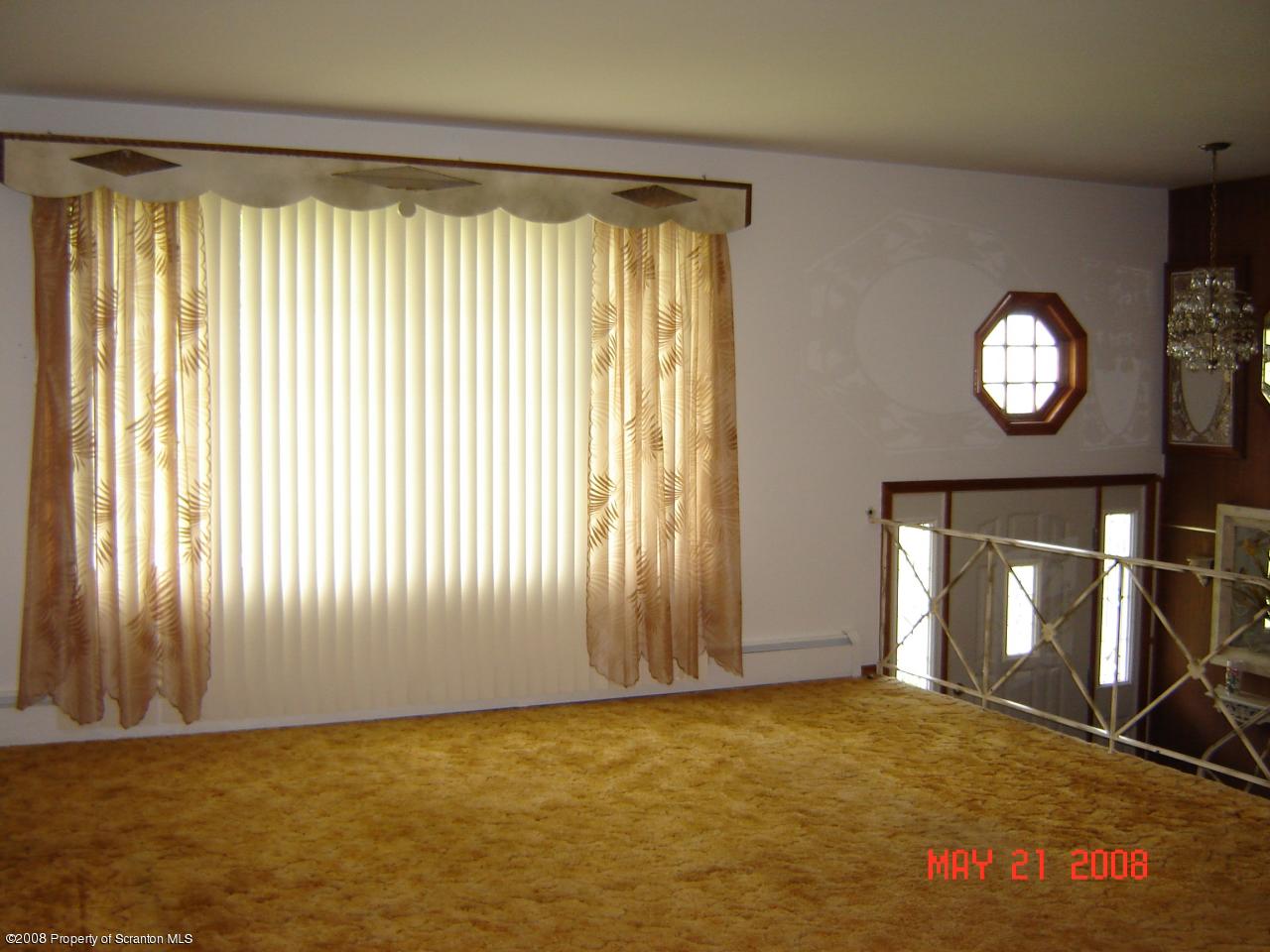 2343 T Rte 720 Moscow, PA 18444 - Photo 3 of 16 an empty room with wooden floor and windows