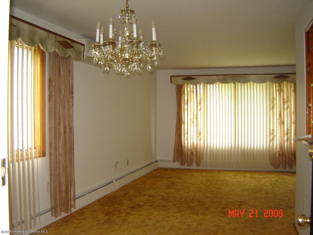 2343 T Rte 720 Moscow, PA 18444 - Photo 6 of 16 a view of a livingroom with a chandelier curtains and large windows