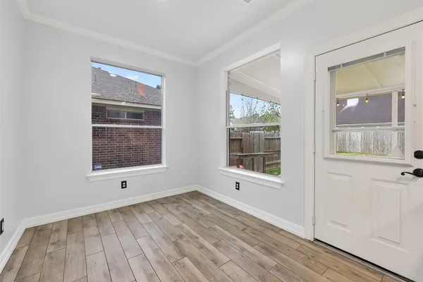 a kitchen with a sink cabinets and wooden floor