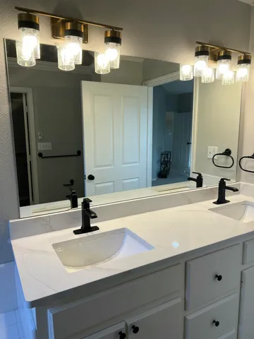 a bathroom with a sink and a mirror