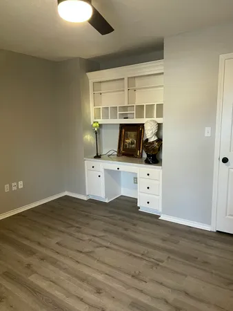 a kitchen with stainless steel appliances a white stove top oven cabinets and a wooden floor