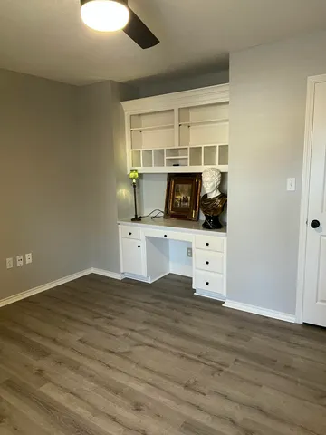a kitchen with stainless steel appliances a white stove top oven cabinets and a wooden floor