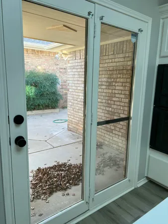 a bathroom with a glass door shower and a sink