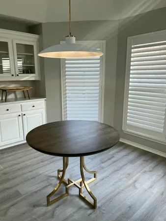 a kitchen with dining table chairs and wooden floor