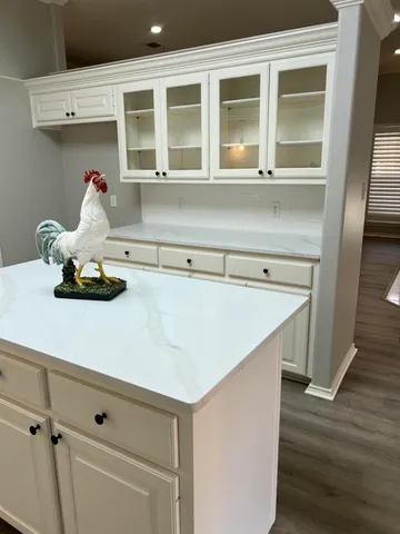 a kitchen with a sink and wooden floor