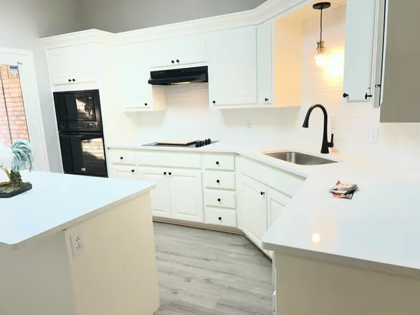 a kitchen with cabinets appliances and a counter