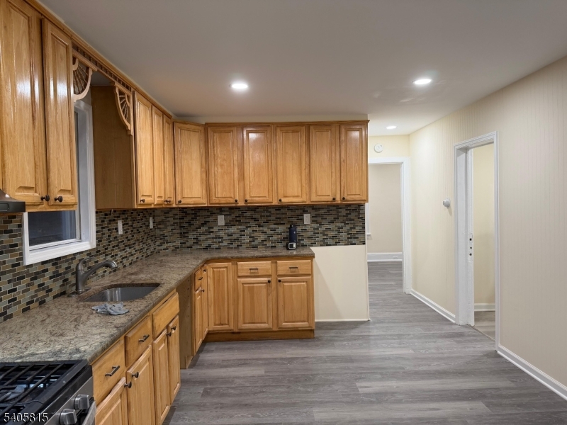 a kitchen with stainless steel appliances granite countertop wooden cabinets a sink and dishwasher