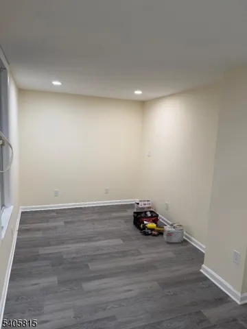 a room with a wooden floor and a window