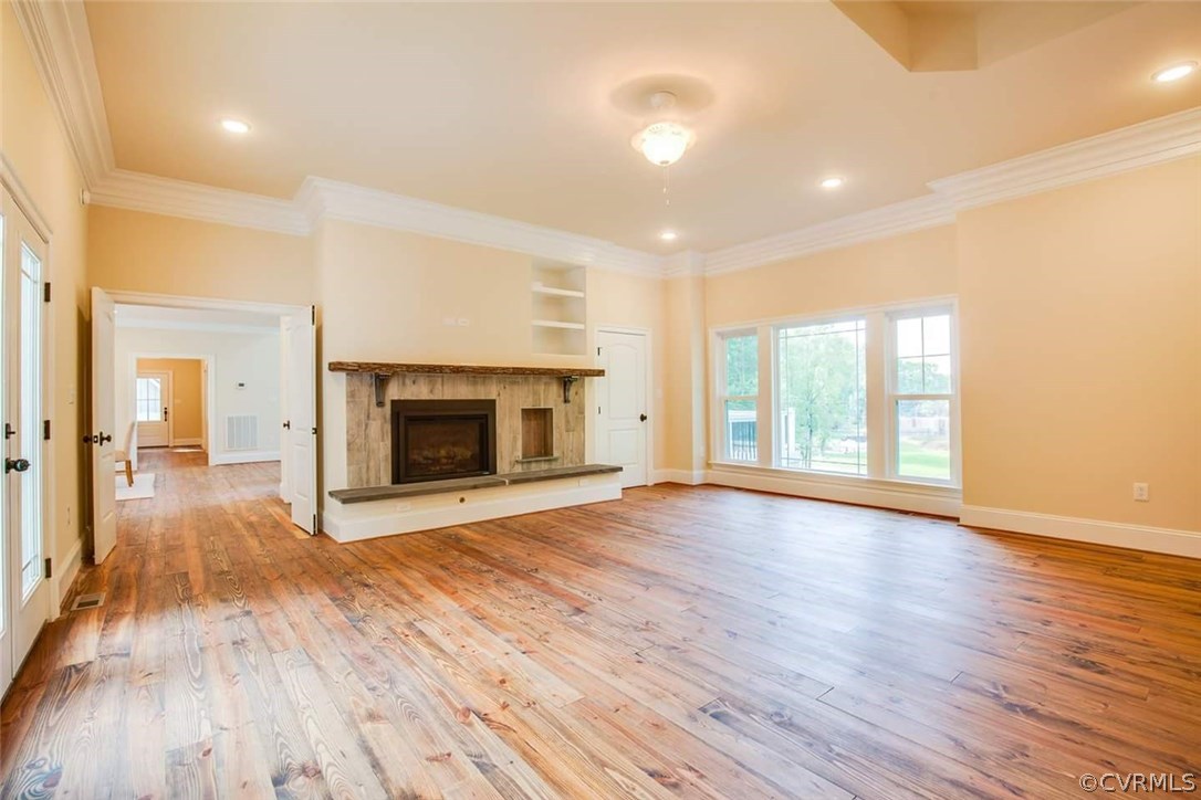 4120 East Old Gun Road Midlothian, VA 23113 - Photo 15 of 25 a view of an empty room with wooden floor fireplace and a window