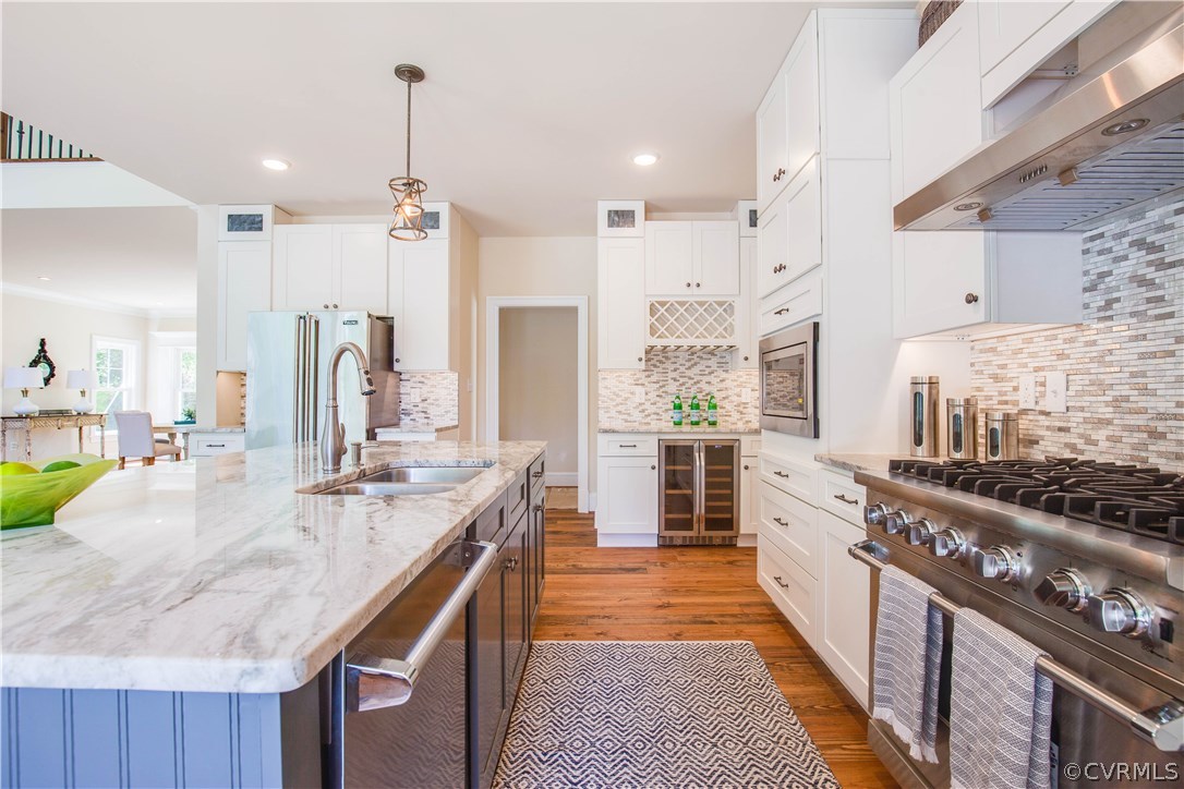 4120 East Old Gun Road Midlothian, VA 23113 - Photo 21 of 25 a large kitchen with kitchen island a stove a sink a refrigerator and a counter space