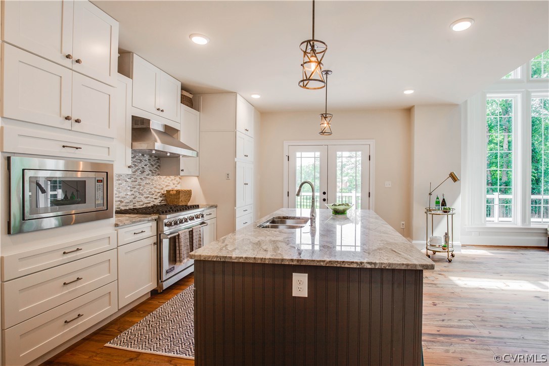 4120 East Old Gun Road Midlothian, VA 23113 - Photo 22 of 25 a kitchen with granite countertop kitchen island white cabinets and appliances