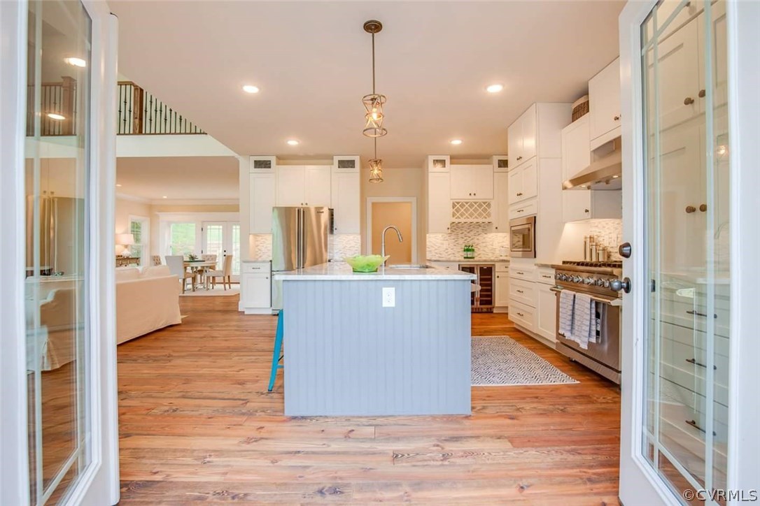4120 East Old Gun Road Midlothian, VA 23113 - Photo 23 of 25 a living room with stainless steel appliances kitchen island granite countertop a refrigerator a oven and a view of living room