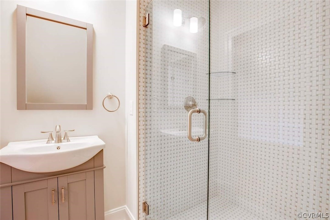 4120 East Old Gun Road Midlothian, VA 23113 - Photo 24 of 25 a bathroom with a sink shower and a mirror