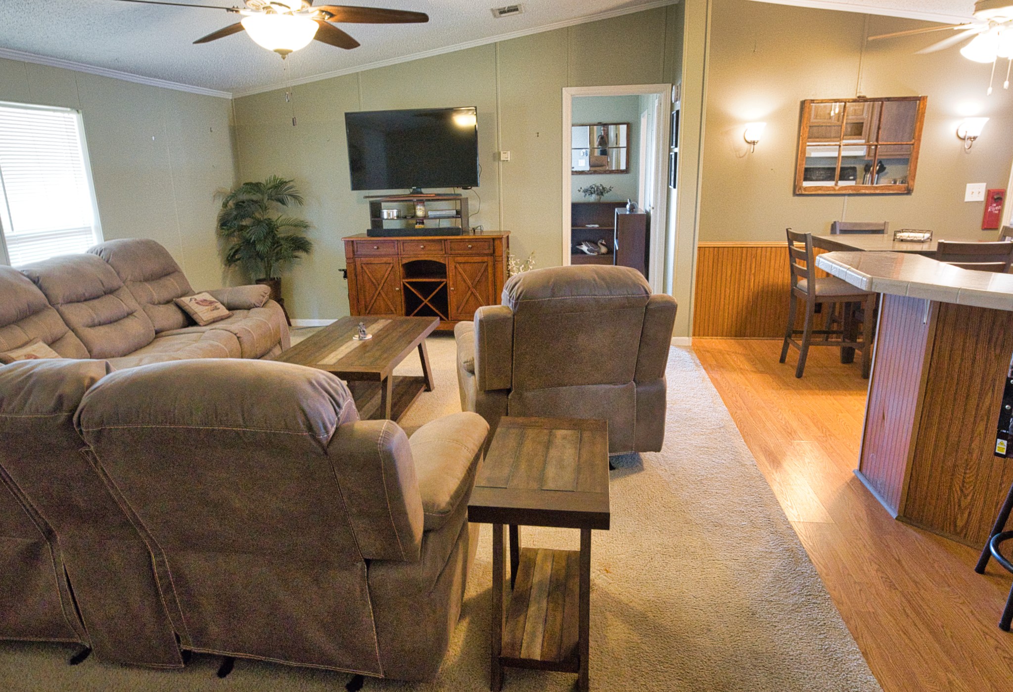 5582 County Road 469 Brazoria, TX 77422 - Photo 13 of 32 a living room with furniture a flat screen tv and kitchen view