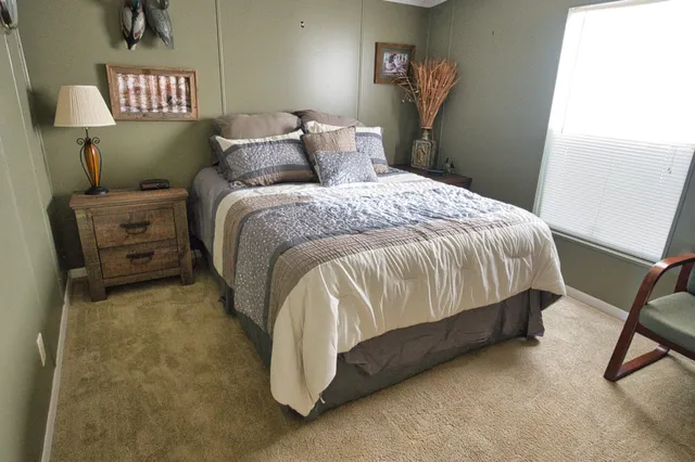 a bed sitting in a bedroom next to a window