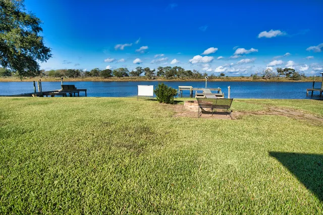 a view of a lake with houses in the back
