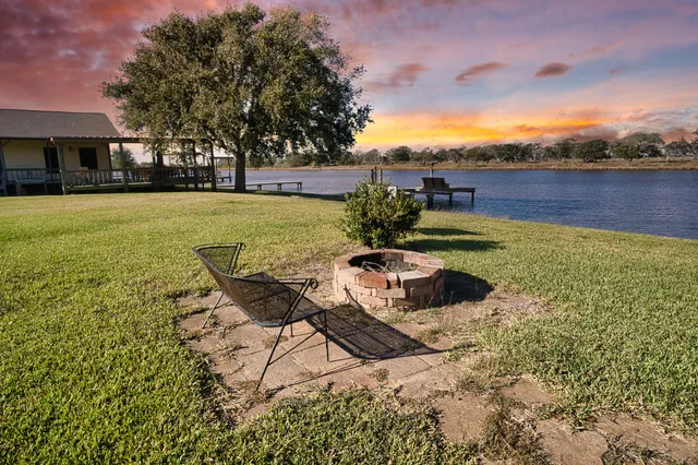 a swimming pool with outdoor seating and yard