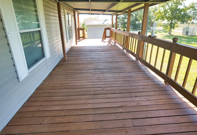 a view of a porch with wooden floor
