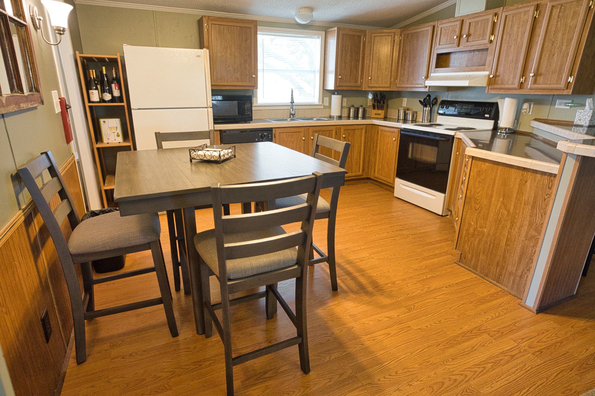 5582 County Road 469 Brazoria, TX 77422 - Photo 9 of 32 a kitchen with stainless steel appliances granite countertop a refrigerator a stove a sink a dining table and chairs with wooden floor
