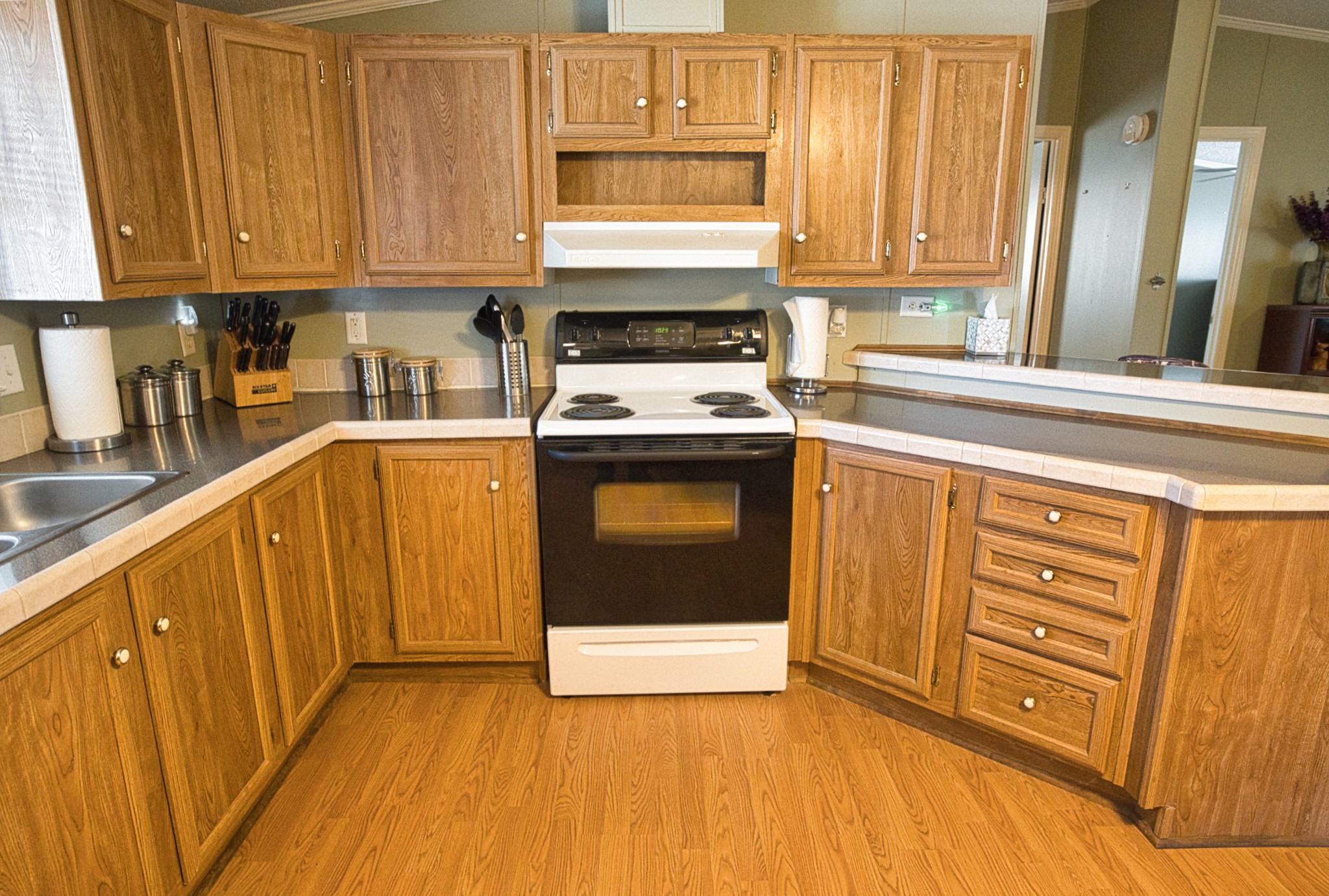 5582 County Road 469 Brazoria, TX 77422 - Photo 10 of 32 a kitchen with stainless steel appliances granite countertop a stove a sink and a microwave