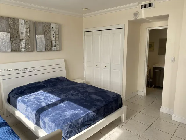 a bedroom with a bed and a walk in closet