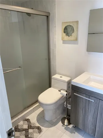 a bathroom with a toilet and a shower curtain